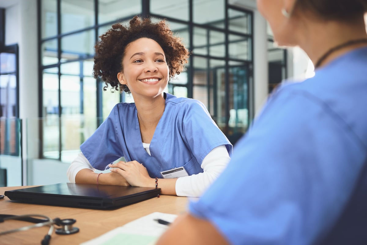 A physician meeting with a colleague to discuss a case in a hospital