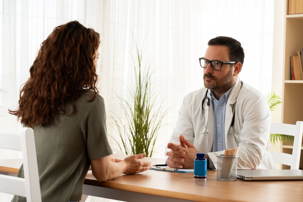 A clinician explaining medical findings to a patient during an examination